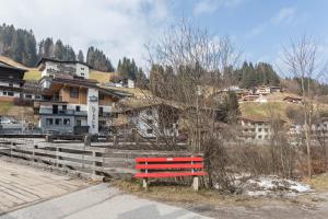 a red bench sitting on the side of a road at Luisalle Top 1 in Auffach