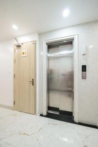 an elevator in an office building with a door at 2Re Hidden Hostel 58 Hàng Bạc in Hanoi