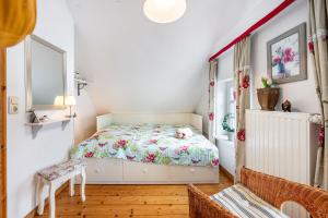 a small bedroom with a bed and a chair at Weitblick in Wesselburen