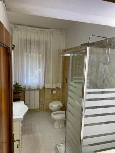 a bathroom with a toilet and a sink at Casa Cesarina in Massa +9 photos