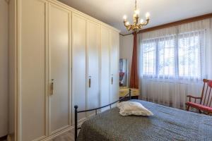 a bedroom with a bed and a chandelier at Casa Cesarina in Massa
