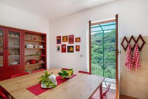 a dining room with a wooden table and a window at La casa di Bosco in Casanova Lerrore