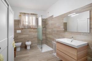 a bathroom with a sink and a toilet at La casa di Bosco in Casanova Lerrore +20 photos