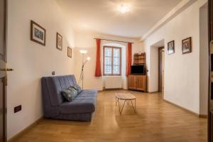 a living room with a blue couch and a table at Residence Lena App 3 with Balcony in Tenno