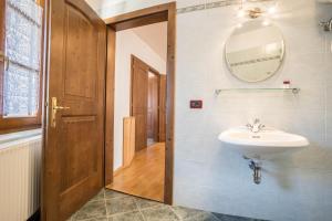 a bathroom with a sink and a mirror at Residence Lena App 3 with Balcony in Tenno +29 photos