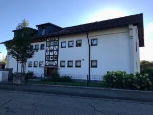 a white building with a black roof at Hopfenglück in Tettnang