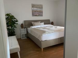 a bedroom with a bed and a potted plant at Hopfenglück in Tettnang