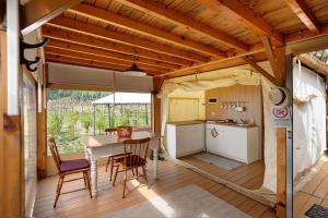 a kitchen with a table and chairs in a house at Glamping Ripa Garden Montestella in Salerno +18 photos