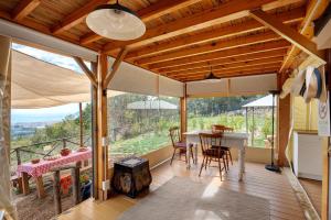 a kitchen and dining room with a table and a view at Glamping Ripa Garden Montestella in Salerno