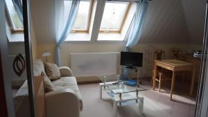 a living room with a couch and a table at Fewo Hiddensee, 2 Personen 40 M² in Wiek auf Rügen