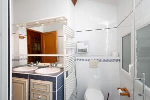 a bathroom with two sinks and a mirror at Le Calmadou in Formiguères +25 photos