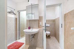 a bathroom with a sink and a toilet at Saarglück - W4 in Beckingen +16 photos