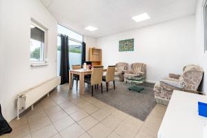 a living room with a table and chairs at Saarglück - W4 in Beckingen