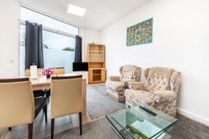 a living room with a table and a couch at Saarglück - W4 in Beckingen
