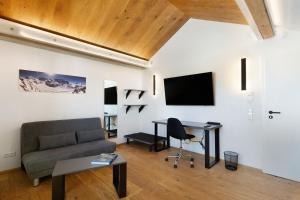 a living room with a couch and a table at Wolf's Apartment Ortenau in Renchen