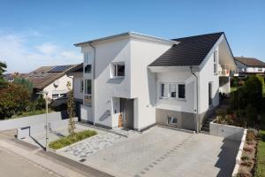 an aerial view of a white house with a driveway at Wolf's Apartment Ortenau in Renchen +8 photos