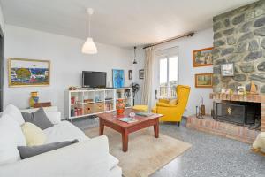 a living room with a couch and a fireplace at Casa Beto in Almuñécar