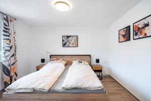 two beds in a room with white walls at Fewo Blumenweg in Elzach +23 photos