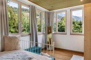 a bedroom with windows and a bed with a view at Apartment Villa Stumm in Stumm