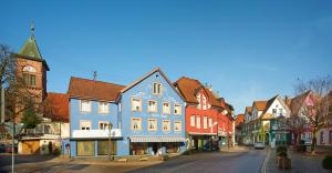 a street in a town with colorful buildings at Fewo Blumenweg in Elzach