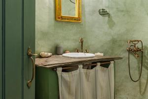 a bathroom with a sink and a shower at Traditional Olive Guesthouse in Fállika