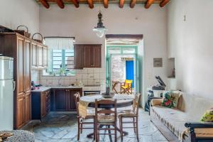 a kitchen with a table and a couch at Traditional Olive Guesthouse in Fállika +12 photos