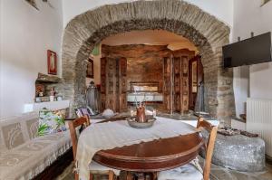 a living room with a table and a couch at Traditional Olive Guesthouse in Fállika