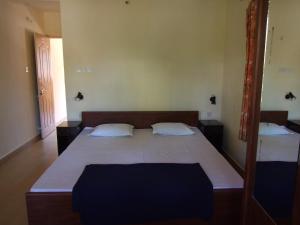 卡蘭古特的住宿－Empire Guest House，一间卧室配有一张大床和两个枕头