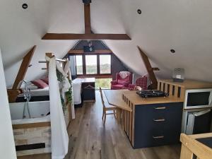 a room with a desk and a bedroom with a bed at " Al'Coppette " Gîte open-space in Comblain-au-Pont
