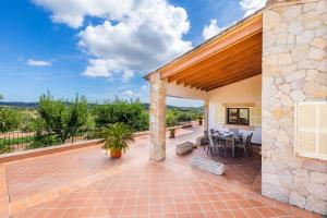 an exterior view of a patio with a table and chairs at Can Bosco in Son Servera