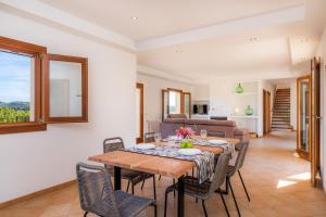 a dining room with a table and chairs at Can Bosco in Son Servera
