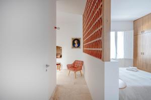 a bedroom with a bed and a chair in a room at Casita Lemos in Triggianello