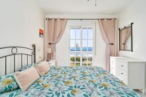 a bedroom with a bed and a window at Jardines del Mar in Torrox