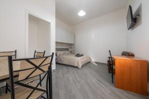 a living room with a bed and a desk at Casa Manu in Assemini
