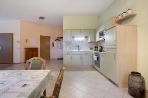 a kitchen with white cabinets and a table and a table and a table at Forst Entdecken in Forst