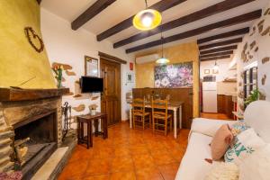 a living room with a couch and a fireplace at Picachico in Laroya