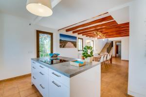 a kitchen with white cabinets and a counter top at Finca Kiana in Sencelles