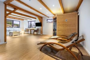 a living room with a wooden wall and a table at Ferienwohnung Silberborth mit Sauna in Seesen
