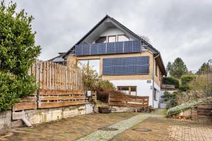 a house with solar panels on the roof at Ferienwohnung Silberborth mit Sauna in Seesen
