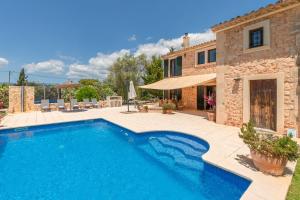 an external view of a villa with a swimming pool at Finca Kiana in Sencelles