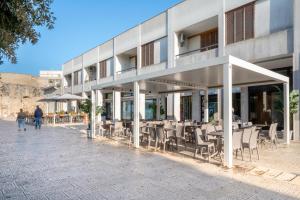 a building with tables and chairs outside of it at Stella Vacanze in Otranto