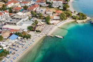 an aerial view of a beach with umbrellas and a resort at Mella Roa - Teal studio in Nydri +13 photos