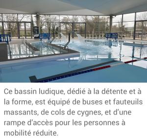 a swimming pool with tables and a swimming pool at Gîte Le Flot in Saint-Florentin