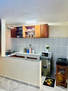 a kitchen with a sink and a counter top at Nimaai Apartment in Narok