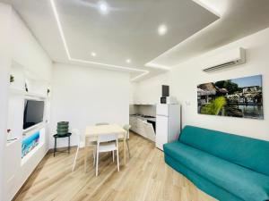 a living room with a blue couch and a table at Villa Raffaella - Privat Garden in Bibione