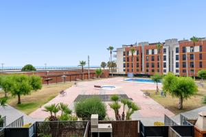 a view of a park with trees and a building at Ática Blue Sea in Cubelles