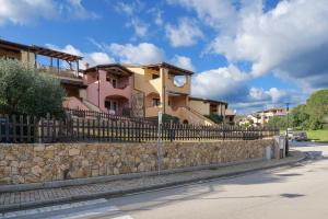 a fence in front of a house on a street at Residence Orizzonti app n 21 in Golfo Aranci