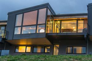 a house with large glass windows on the side of it at Chalet du Saix in Châtel