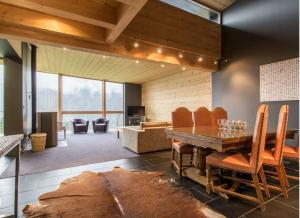 a living room with a table and a fireplace at Chalet du Saix in Châtel