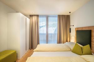 a bedroom with a bed and a large window at Stoana Apt 4-1 in San Giacomo